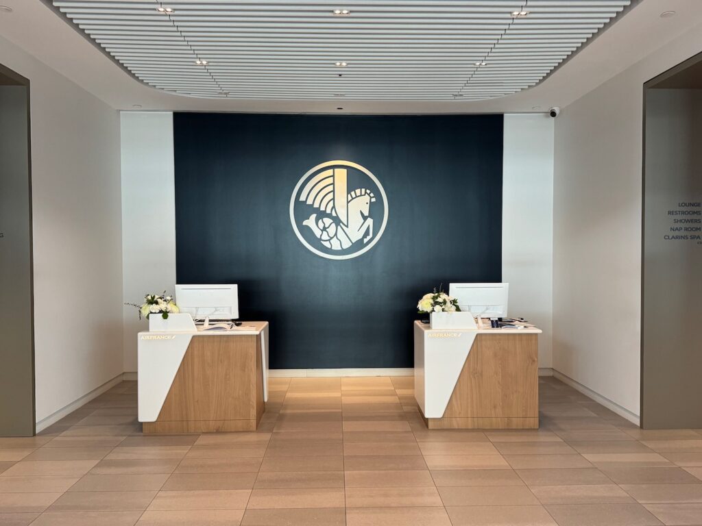 a room with white and black walls and a black wall with a logo on the wall