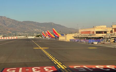 a group of airplanes parked on a runway