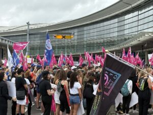 a group of people holding flags in front of a building