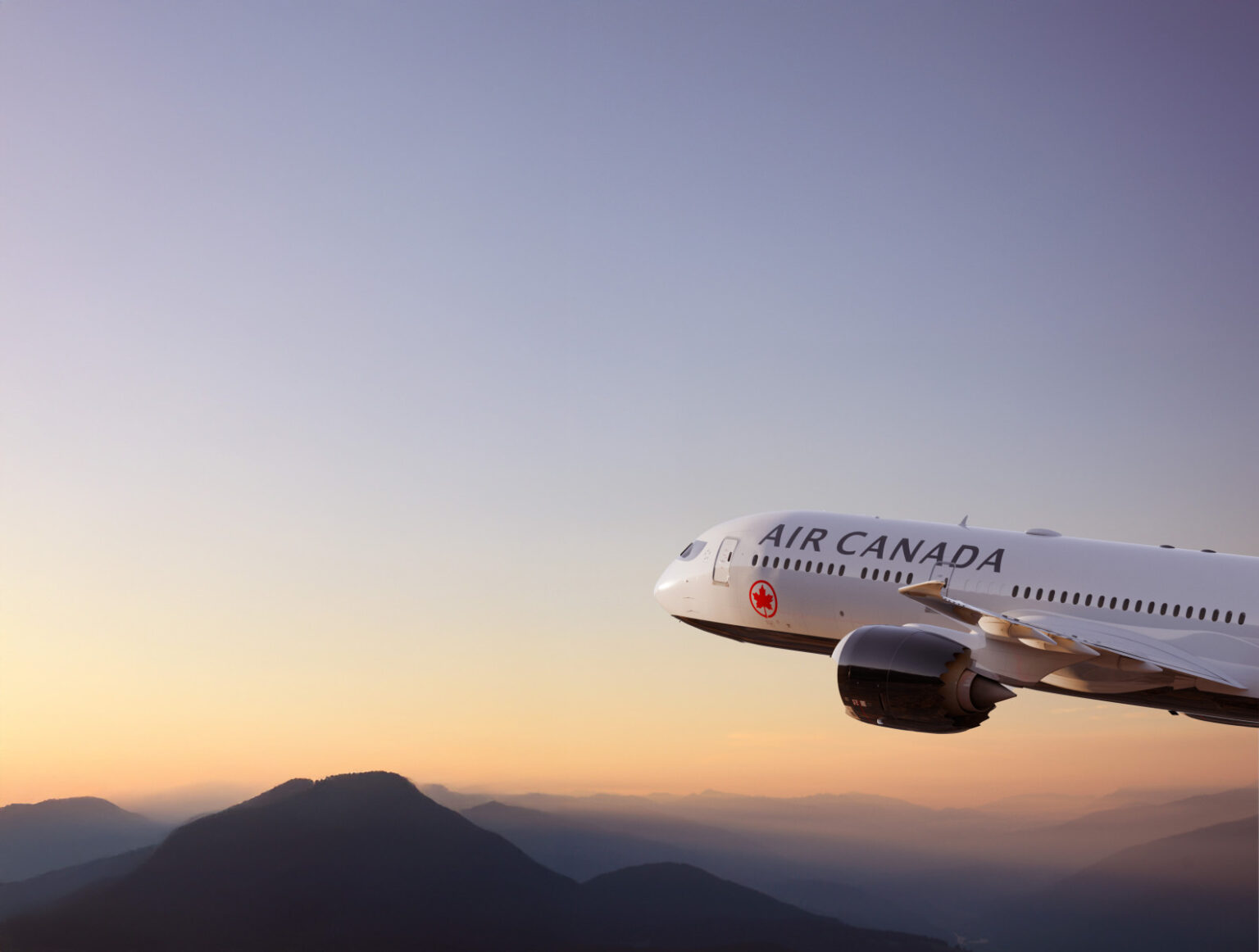 a plane flying over mountains