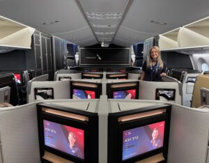 a woman standing in a room with several monitors