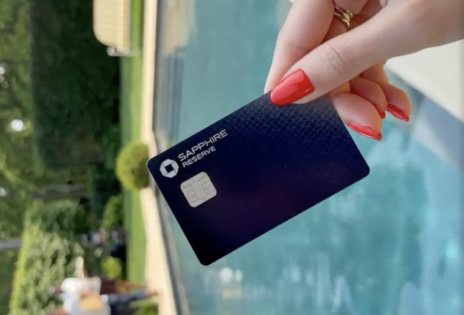 a hand holding a credit card