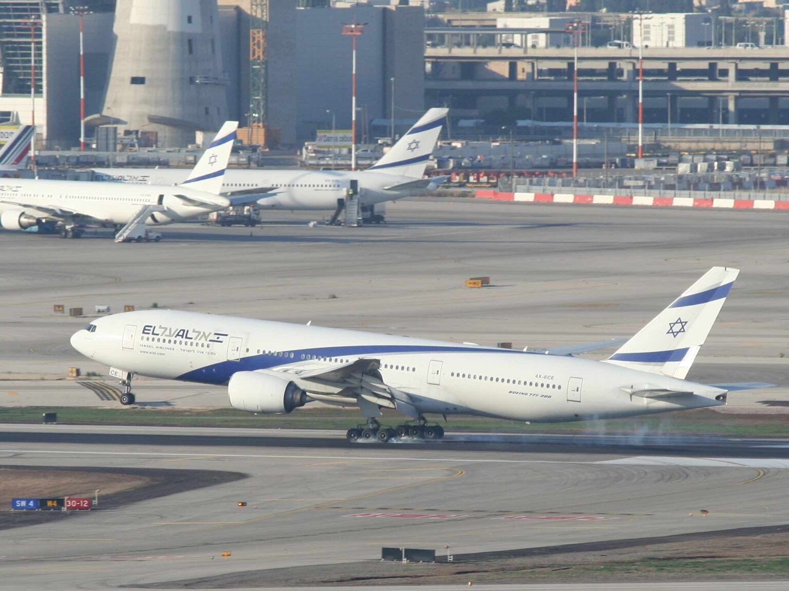 a group of airplanes on a runway