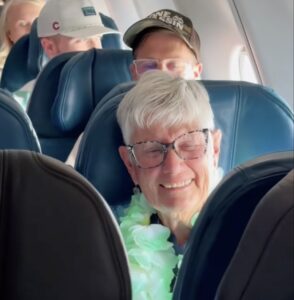an older woman sitting in a plane