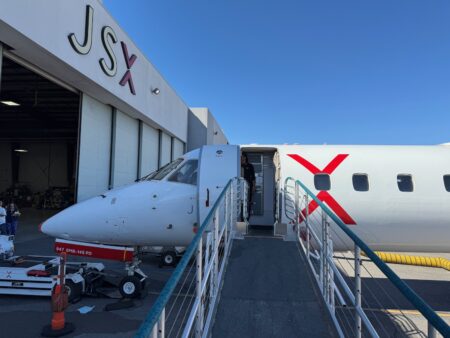 a plane with a ladder and a man standing in front of it