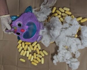 a stuffed toy and yellow pills