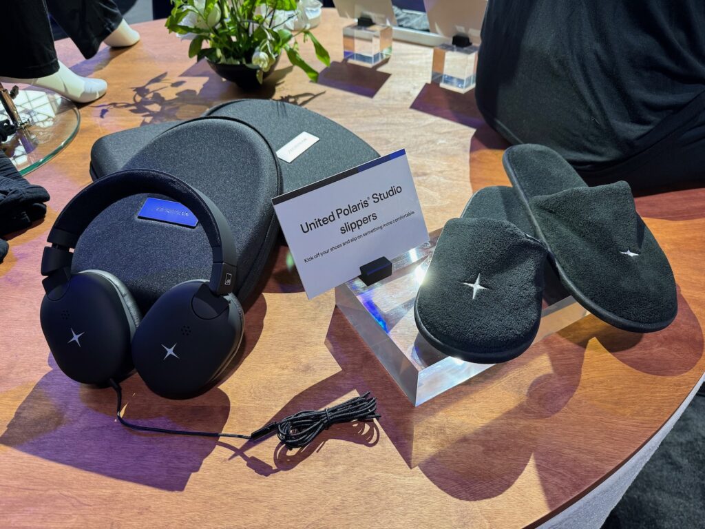 a table with black slippers and headphones