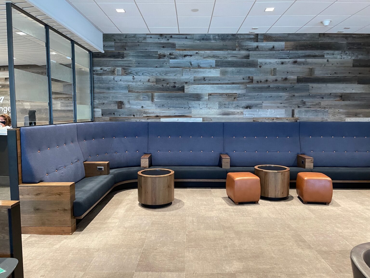 Signage for Alaska Airlines Lounge at LAX, featuring "BE OUR GUEST" and "Welcome," with oneworld Priority logo and Alaska Lounge branding.