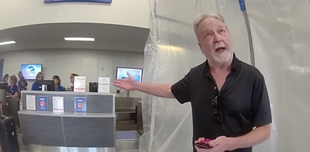 a man standing in front of a computer