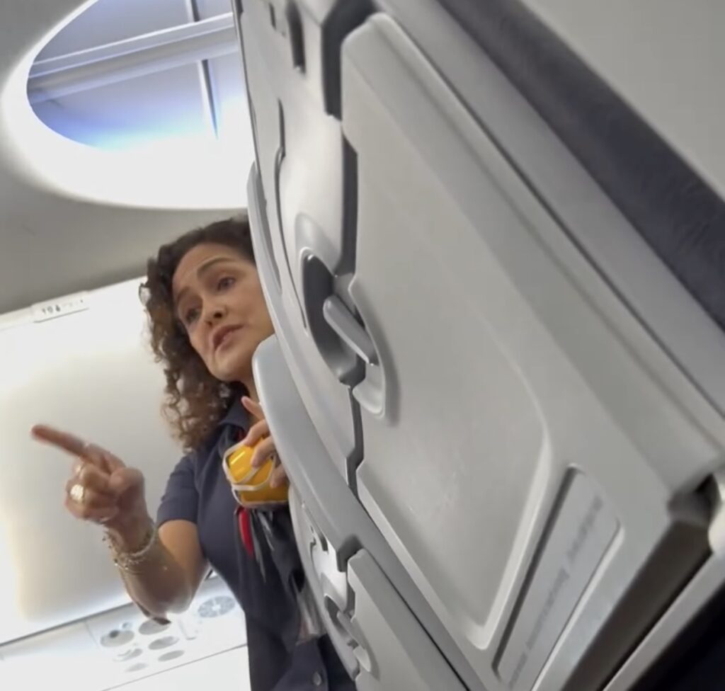 a woman pointing at an airplane