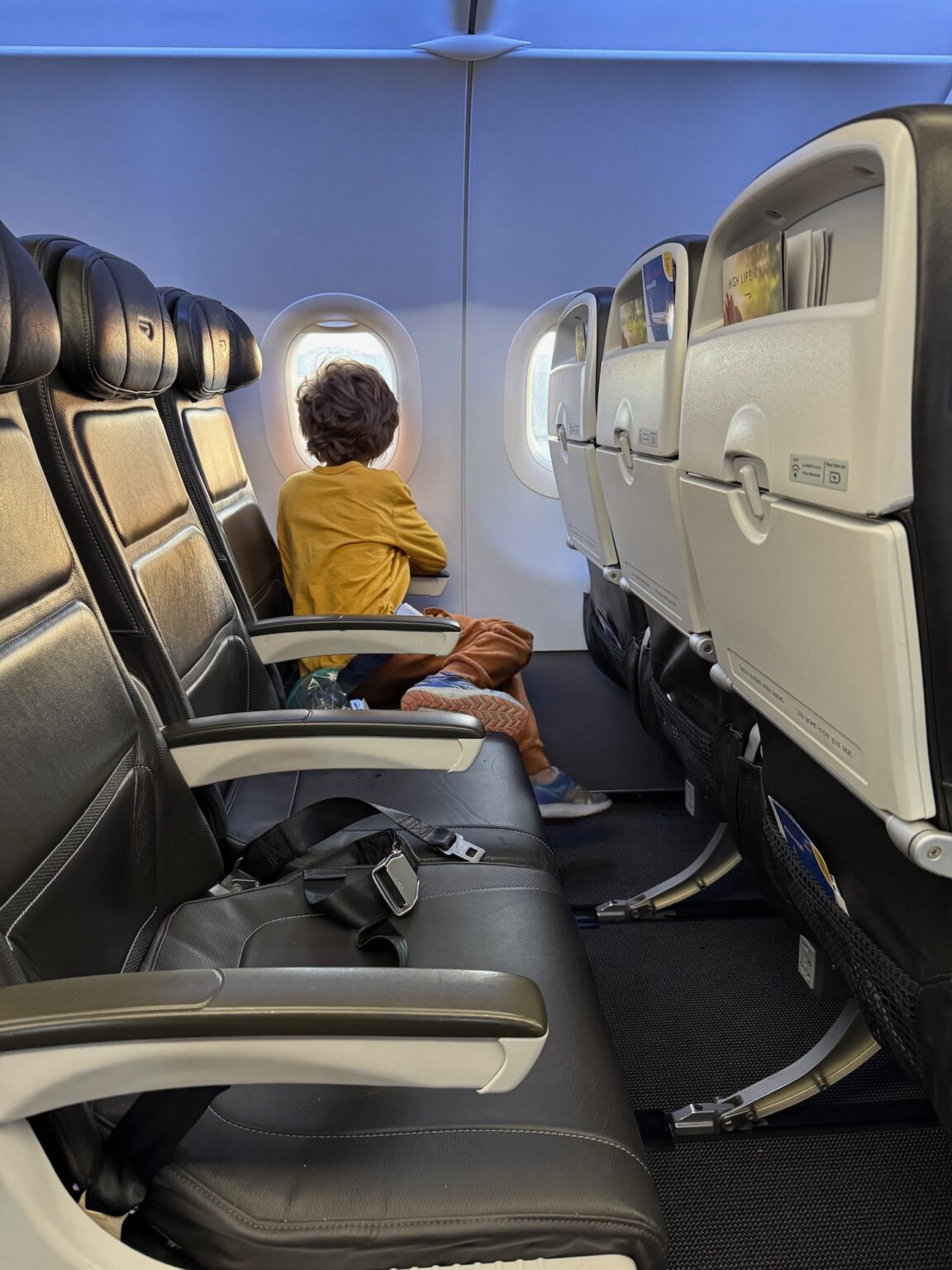 a child sitting on a plane