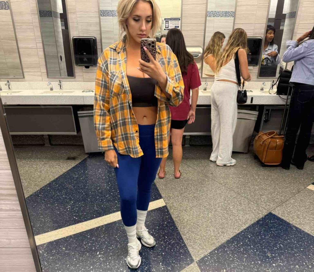 a woman taking a selfie in a bathroom