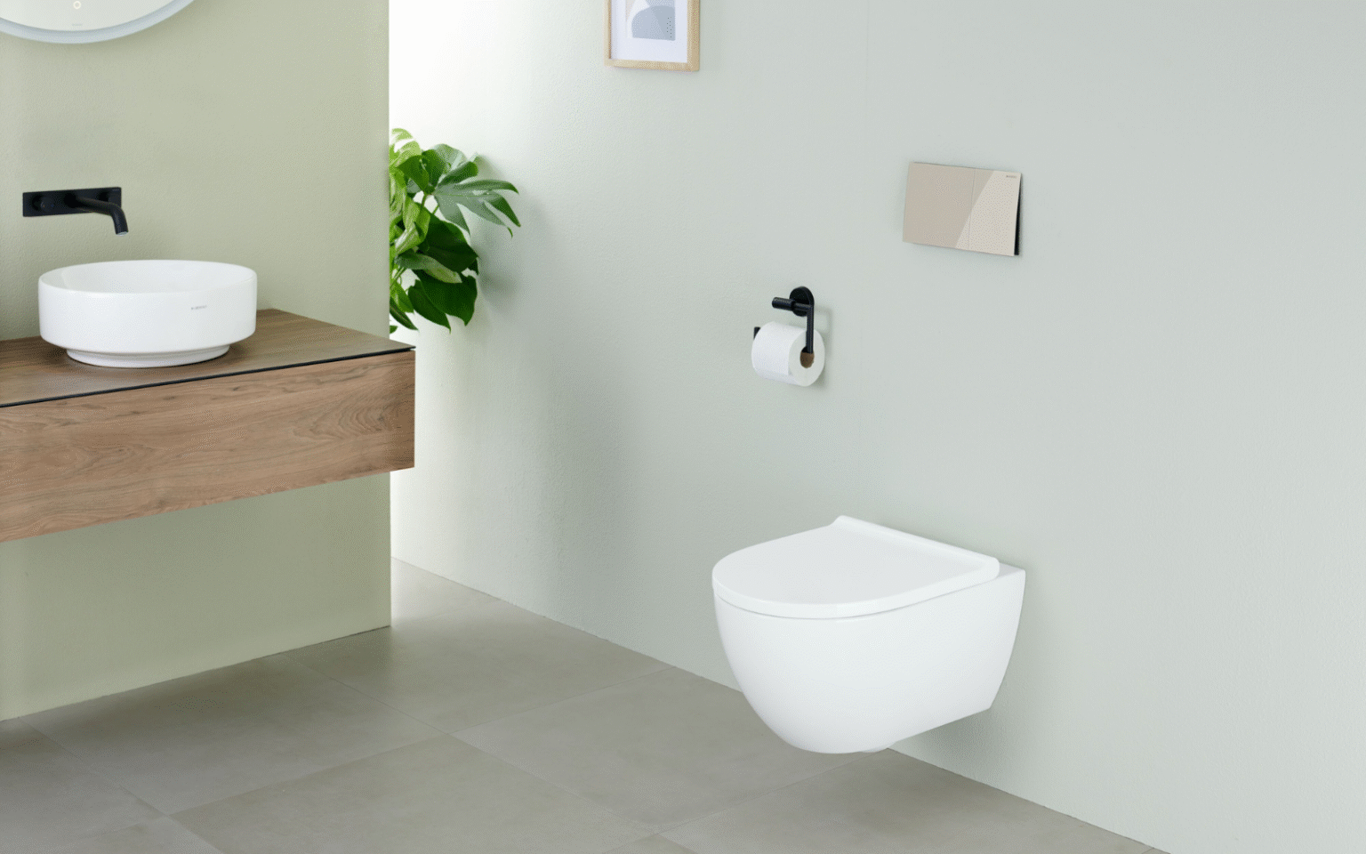 Geberit shower toilet mounted onto pale green wall, a chrome flush plate sits above