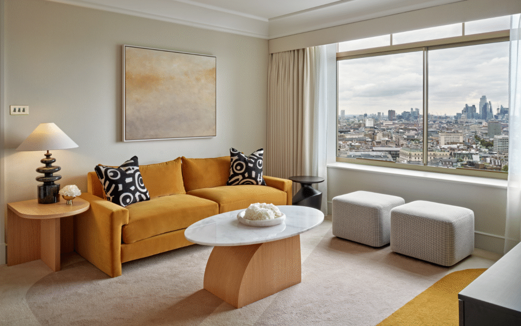 Ceramic lighting by Northern Lights – giving modern a glow Lounge area in guest bedroom of Hilton Park Lane. Large window shows views across London while a yellow sofa is positioned besides a side table with Northern Lights ceramic lamp