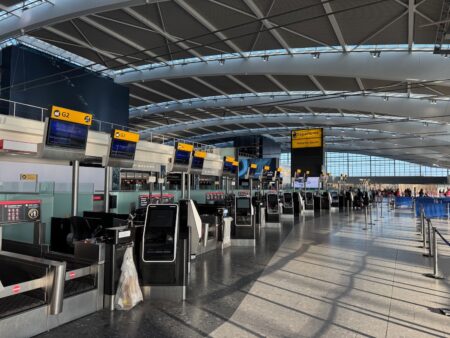 an airport terminal with a few people