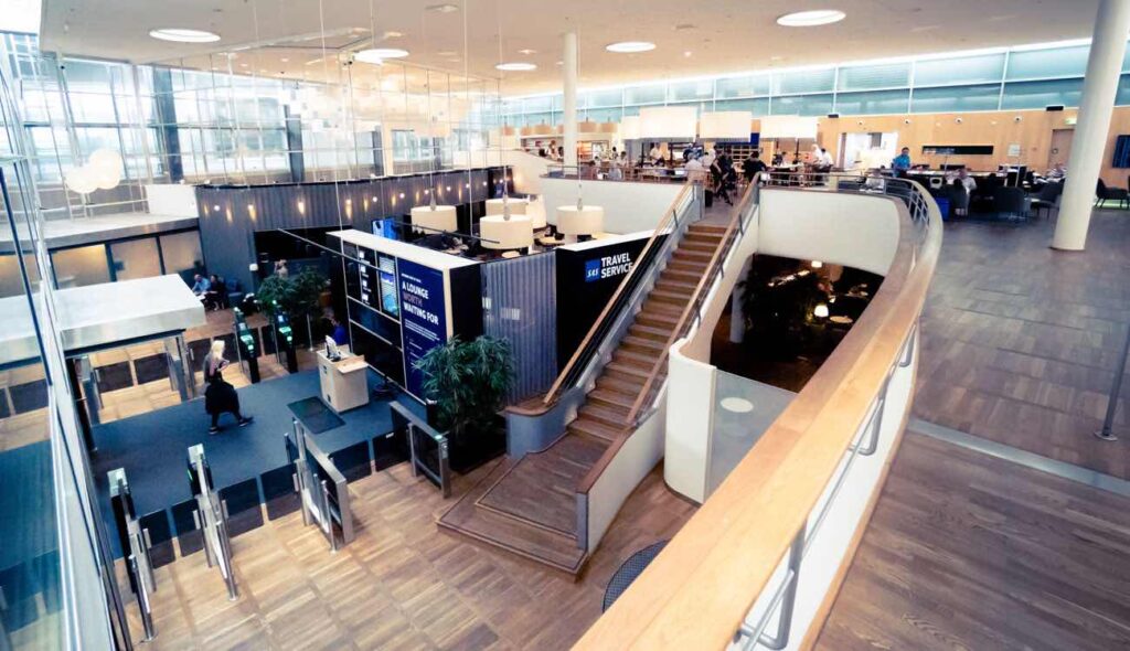 a building with stairs and people walking around