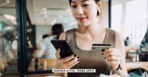 a hand holds a credit card