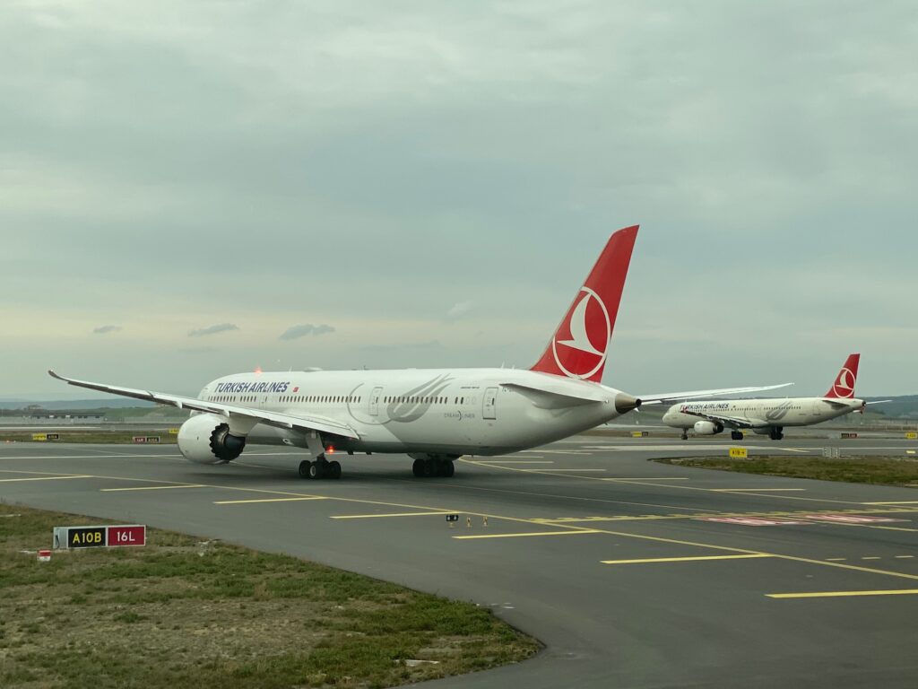 a group of airplanes on a runway