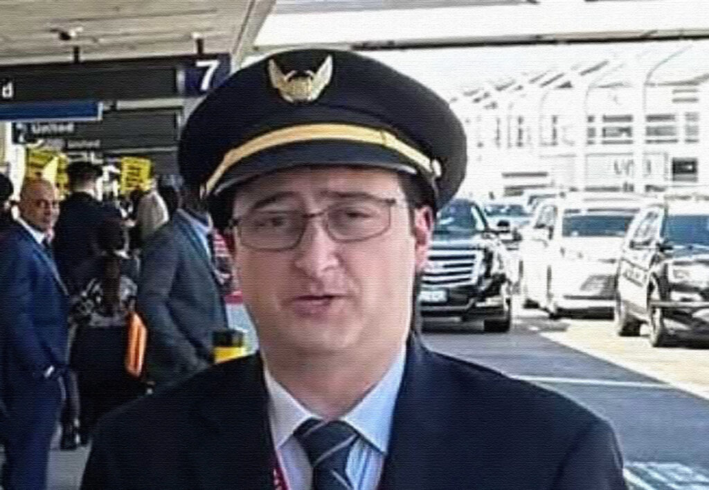 a man in a suit and hat