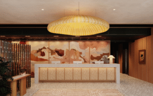 Lobbying for attention: the language of hotel lobby design entrance and reception in Aethos London with large statement pendant light above textured carpet and mural on back wall