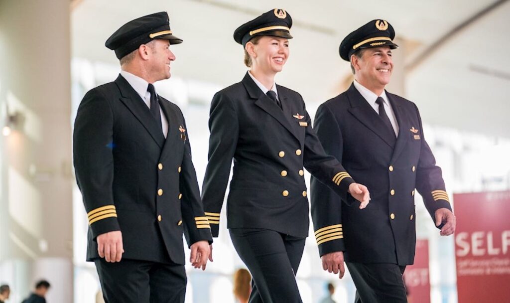 U.S. Airlines Still Struggling To Fill Cockpits As Pilot Shortage Persists a group of people in uniform