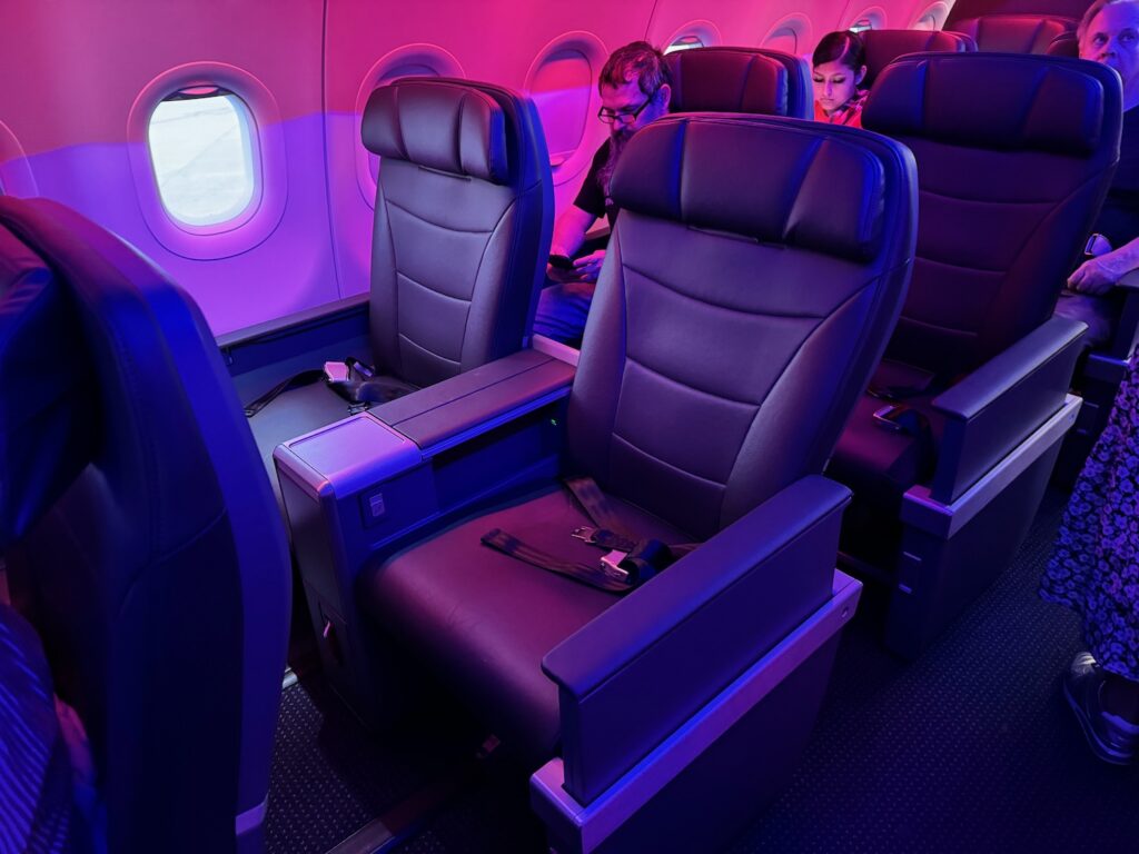Review: American Airlines A321neo First Class a group of people sitting in a plane