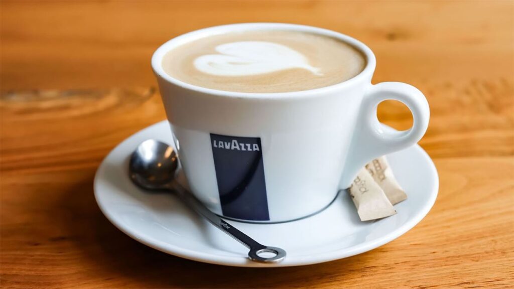 American Airlines Upgrades Coffee: Lavazza Coming To Flights And Lounges a cup of coffee with a heart design on top of it