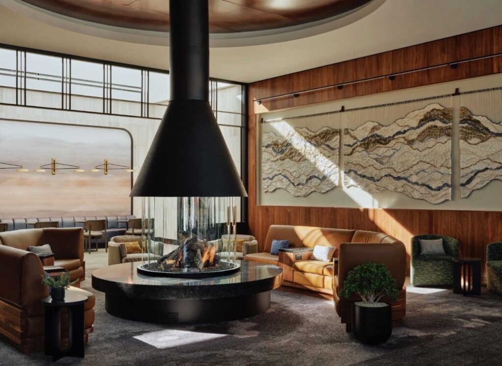 American Express And Delta Just Made Salt Lake City One Of The Best Airport Layovers In America a room with a fireplace and couches