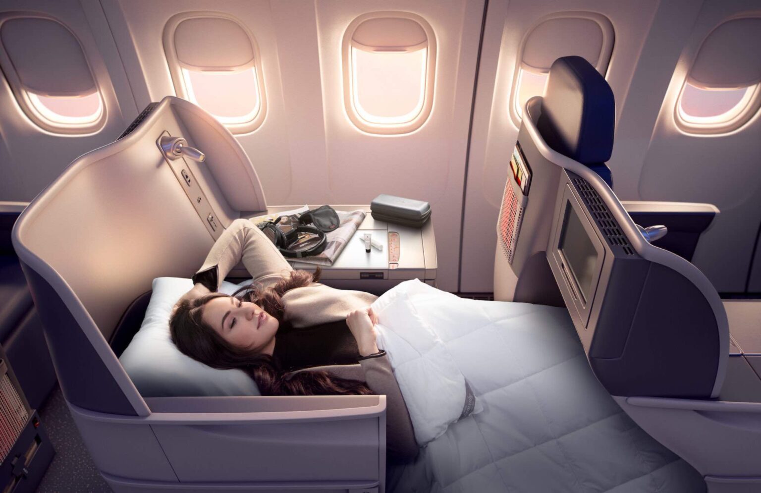 Delta Air Lines Bets Its Future On The Affluent Flyer a woman lying in a bed