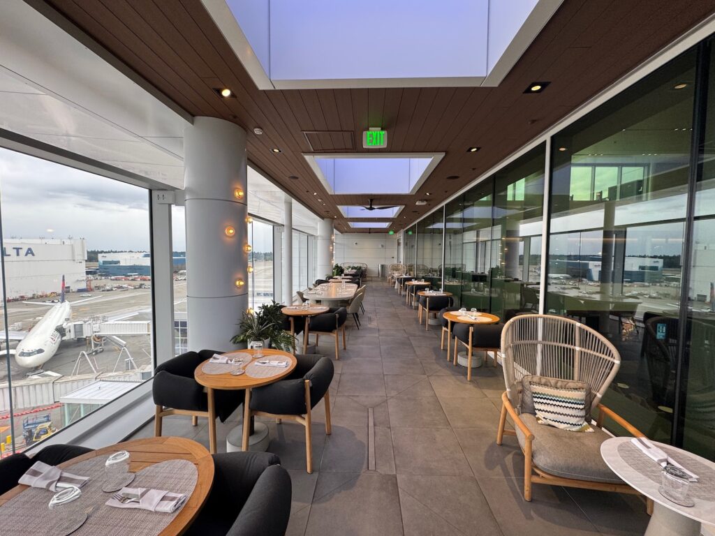 Review: Delta One Lounge Seattle (SEA) a room with tables and chairs
