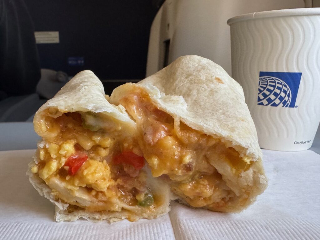 I Tried The Denver Omelet Breakfast Burrito On United Airlines… a burrito with a bite taken out of it