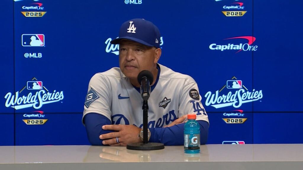 LA Dodgers Manager Suggests Canadian Government “Intent” Behind Delayed Flight From Toronto To Los Angeles a man sitting at a microphone