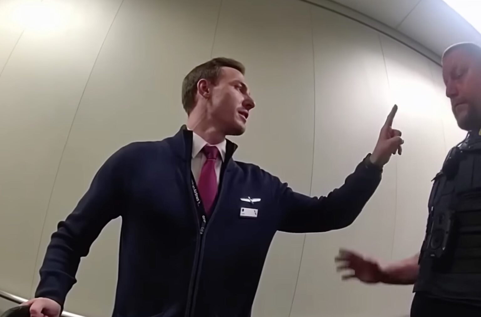 From American Airlines To Alcoholics Anonymous: AA Flight Attendant’s Drunken Meltdown At DFW a man in a suit pointing at another man