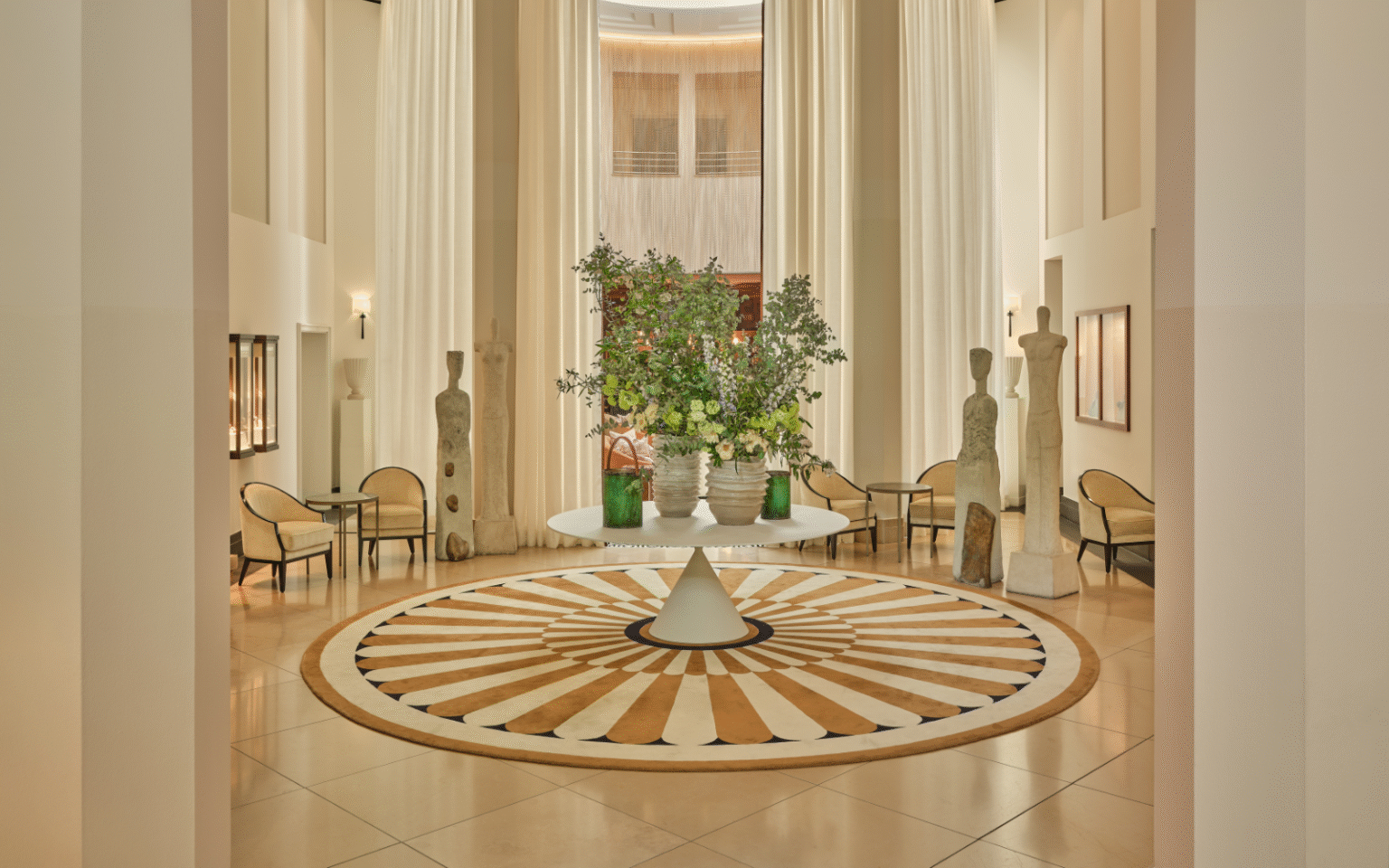 New appointments from Rocco Forte Hotels Lobby of The Charles Rocco Forte Hotel, with central table with floral arrangement and intricate circular pattern floor