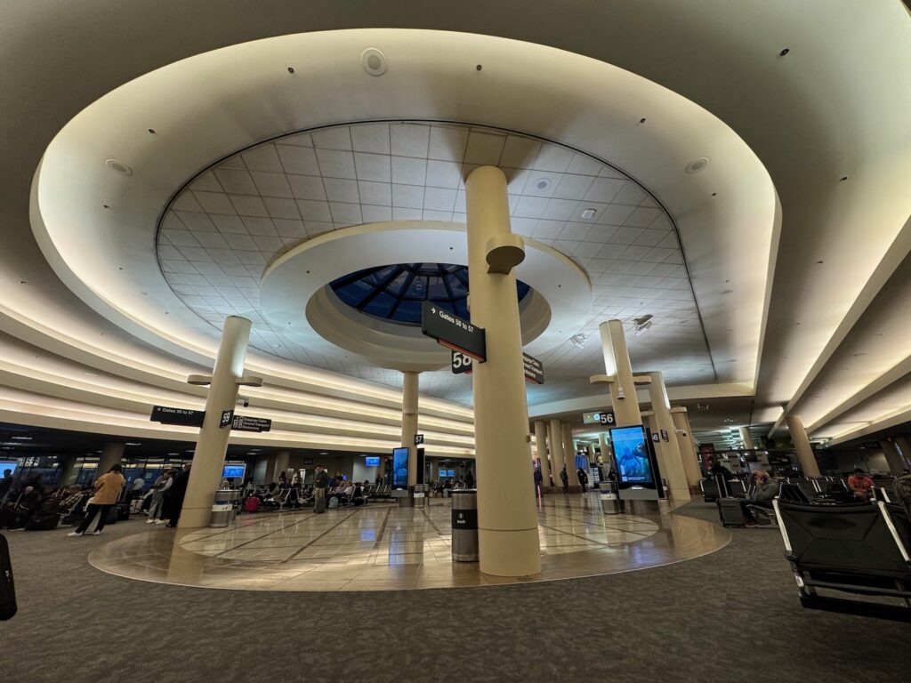 American, JetBlue, And Spirit Move Out As LAX Terminal 5 Faces Demolition a large circular building with many people in it