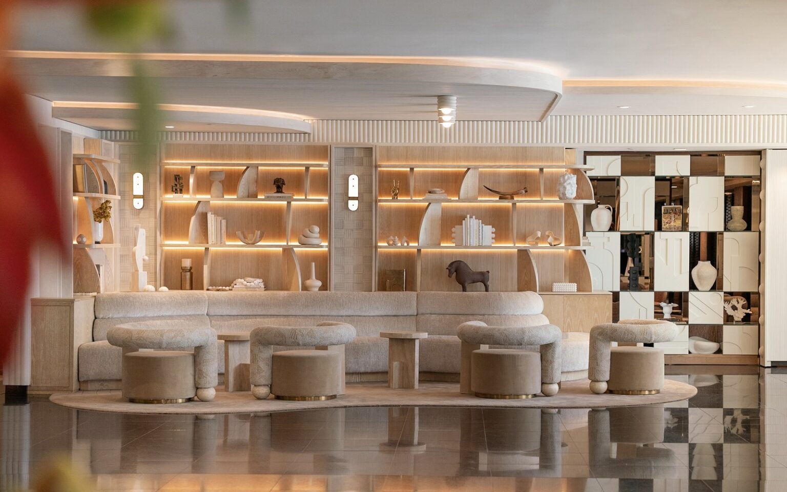 French refinement meets California lifestyle – Sofitel Los Angeles at Beverly Hills unveils a chic redesign round tub seating in front of shelving display in wood and white in hotel lobby Sofitel Los Angeles at Beverly Hills