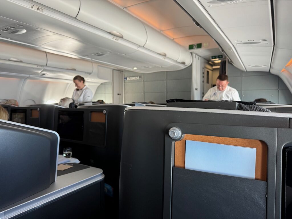 Review: SAS A330 Business Class (Copenhagen – San Francisco) a group of people sitting in an airplane