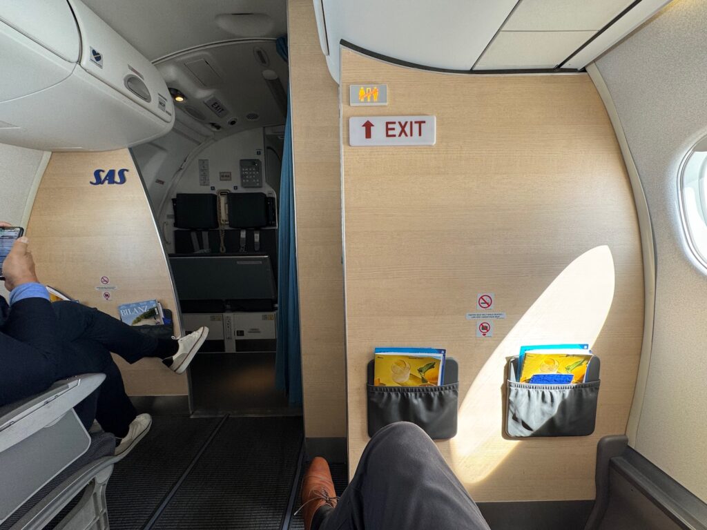 Onboard SAS E195LR From Zurich – Copenhagen, A Premium Cabin Review a person sitting in a chair