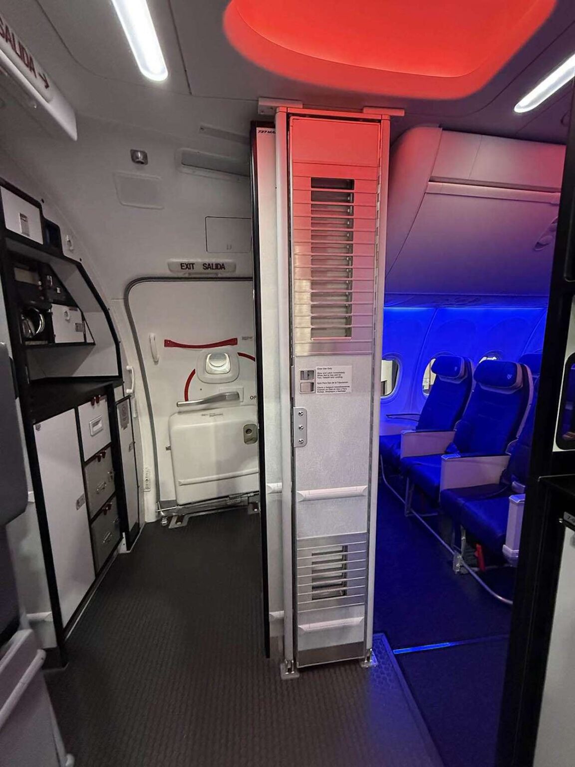 United Airlines Delays Use Of Secondary Flight Deck Barriers an airplane with a door open