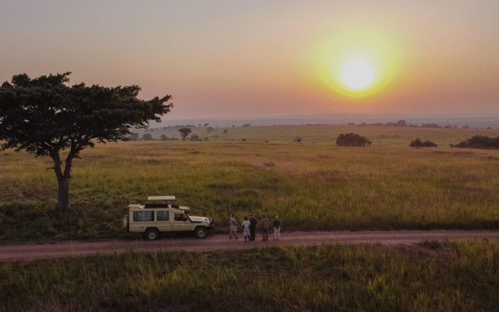 Sneak peek: Kulu Ora Lodge from WildPlaces sunset over savannah in Uganda with thorn tree and landrover