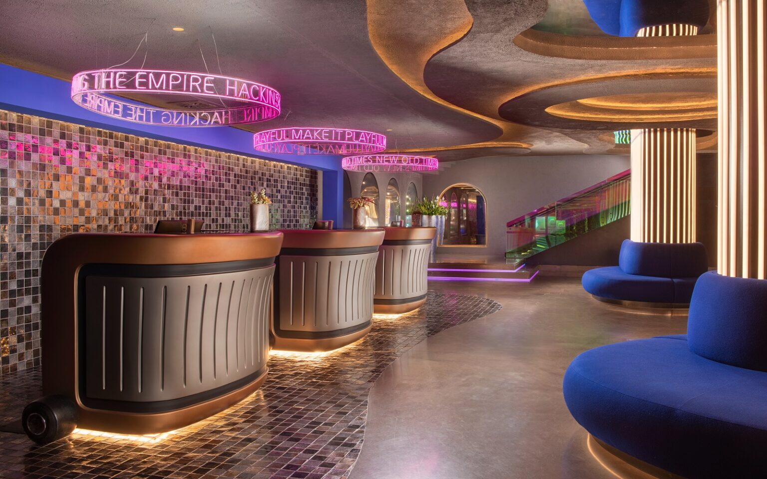 nhow Hotels & Resorts opens its second Italian property in Rome blue couches, neon lighting and reception desks in nhow Roma lobby
