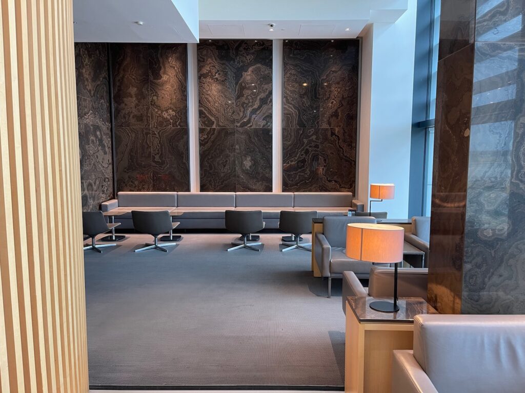 a hallway with a sign and a glass wall