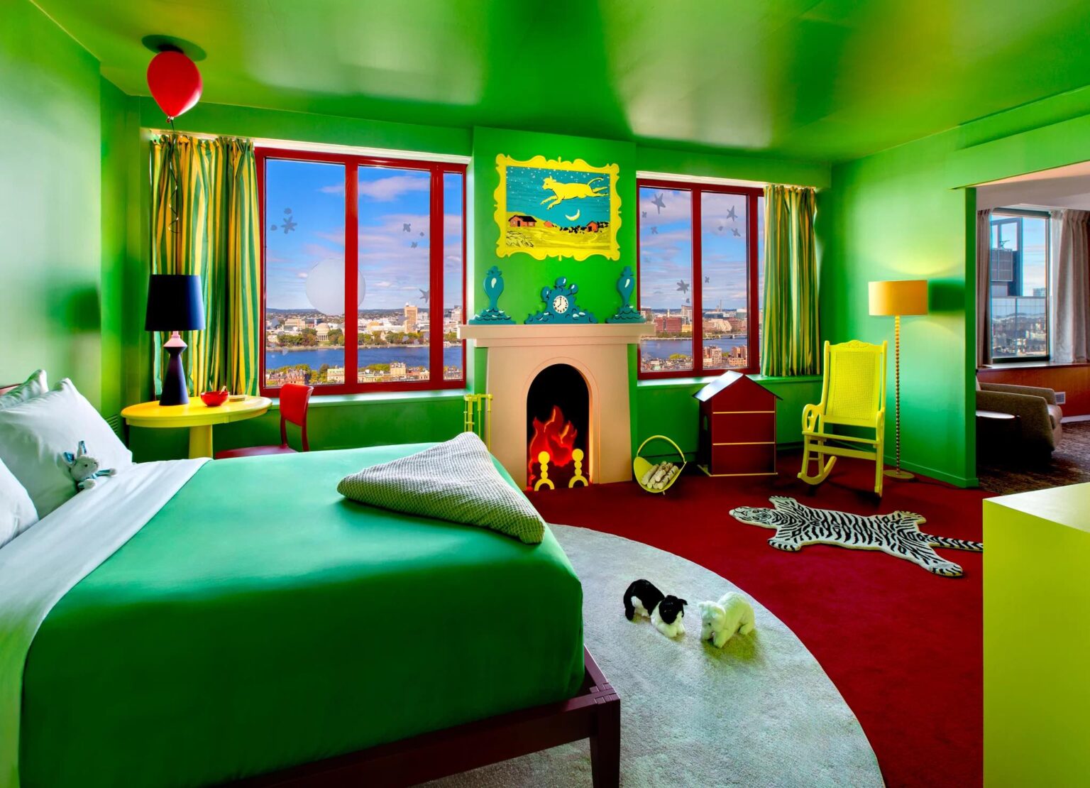 a bedroom with a green bed and a fireplace