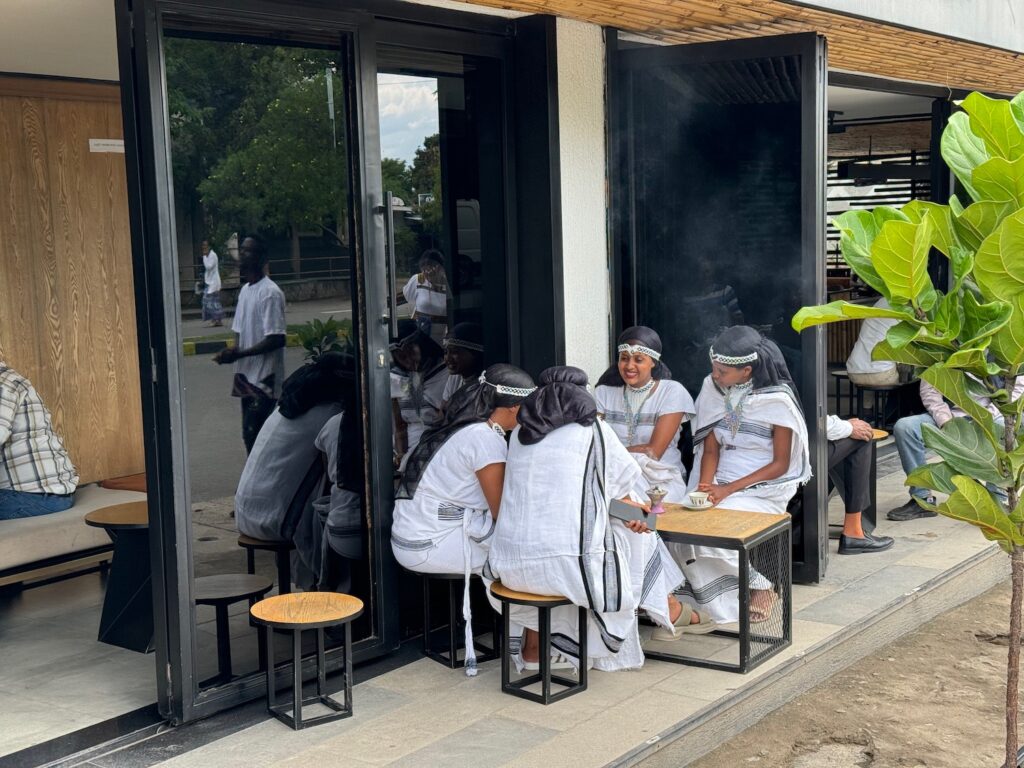 a group of women sitting outside a building