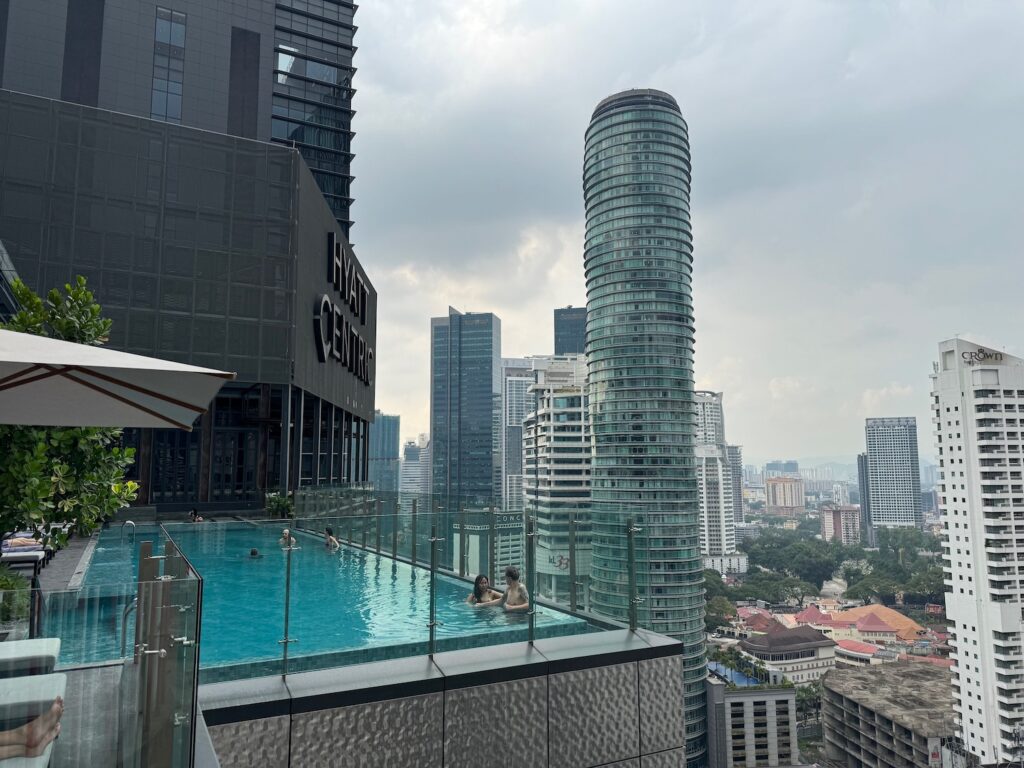 Hyatt Centric City Centre Kuala Lumpur: Great Location people in a pool on a rooftop overlooking a city