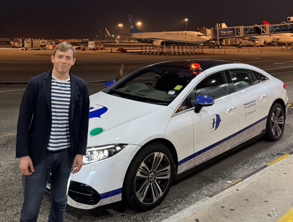 a man standing next to a car