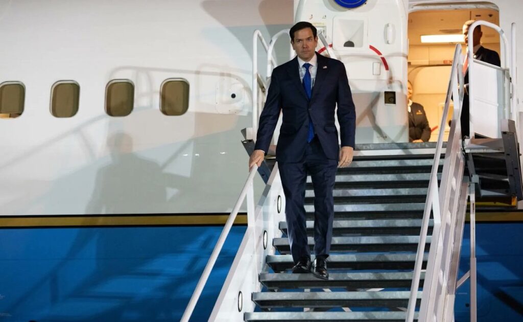 a man in a suit walking up stairs