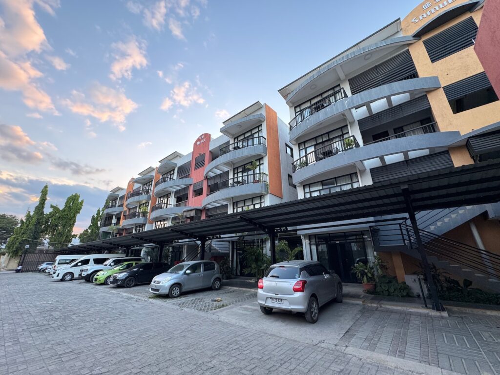 a parking lot with cars parked in front of a building