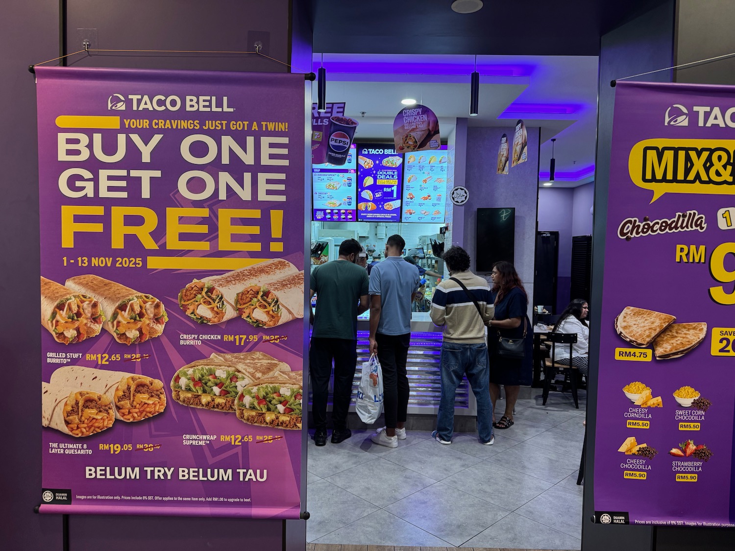people standing in front of a food stand