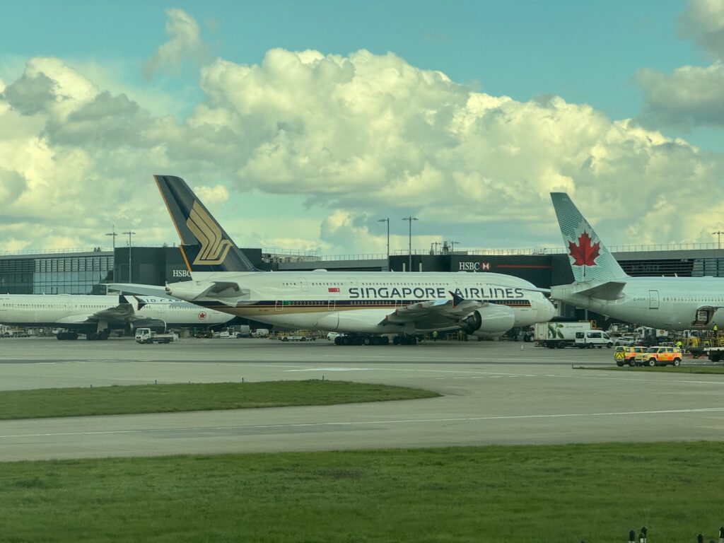Booked! A Colossal Review Trip On Starlux, Thai, Malaysia, Garuda Indonesia, Singapore Airlines, And Aer Lingus a group of airplanes parked at an airport